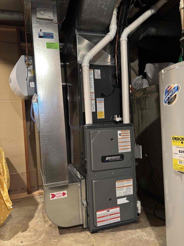 Completed full air conditioning system replacement including outdoor condenser unit and indoor air handler. Removed existing equipment and installed new condenser on concrete pad against exterior wall with proper clearances. Mounted electrical disconnect box on exterior wall per code requirements. Installed new air handler in basement mechanical room adjacent to existing furnace. Connected refrigerant lines between outdoor and indoor units with proper insulation. Ran condensate drain lines using PVC piping with appropriate pitch and termination. Completed all electrical connections and verified proper voltage and amperage. Pressure tested refrigerant system, evacuated to proper micron level, and charged system to manufacturer specifications. Verified all safety controls, thermostat communication, and system operation through multiple heating and cooling cycles. System operating within normal parameters with proper airflow and temperature differential across coil.