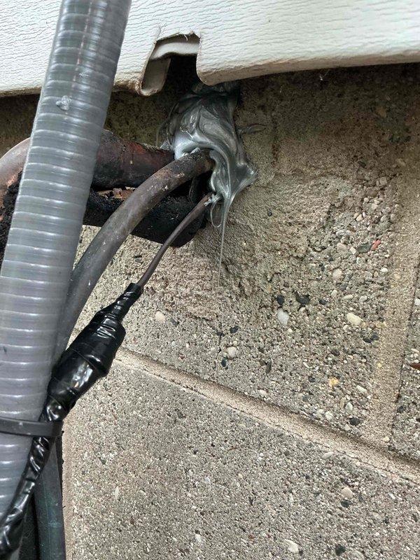 Responded to no heating or cooling complaint with blower fan failure on 26-year-old Lennox system. Upon arrival, confirmed complete loss of airflow at indoor unit with no operation in heating or cooling modes. Inspected outdoor unit and verified no frozen coils or refrigerant leaks present. Investigated indoor air handler and discovered severely deteriorated wiring and electrical connections at blower motor, with visible corrosion on copper conductors and degraded insulation materials. Found compromised wire penetrations through foundation wall with failed sealing materials allowing moisture intrusion. Documented extensive electrical component deterioration and corroded copper piping connections in crawlspace area. Due to age of equipment and extent of electrical system degradation, recommended system replacement as most cost-effective solution. Provided customer with detailed assessment and replacement options.