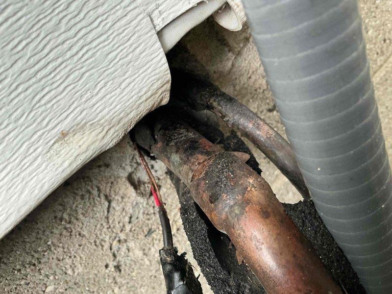 Responded to no heating or cooling complaint with blower fan failure on 26-year-old Lennox system. Upon arrival, confirmed complete loss of airflow at indoor unit with no operation in heating or cooling modes. Inspected outdoor unit and verified no frozen coils or refrigerant leaks present. Investigated indoor air handler and discovered severely deteriorated wiring and electrical connections at blower motor, with visible corrosion on copper conductors and degraded insulation materials. Found compromised wire penetrations through foundation wall with failed sealing materials allowing moisture intrusion. Documented extensive electrical component deterioration and corroded copper piping connections in crawlspace area. Due to age of equipment and extent of electrical system degradation, recommended system replacement as most cost-effective solution. Provided customer with detailed assessment and replacement options.