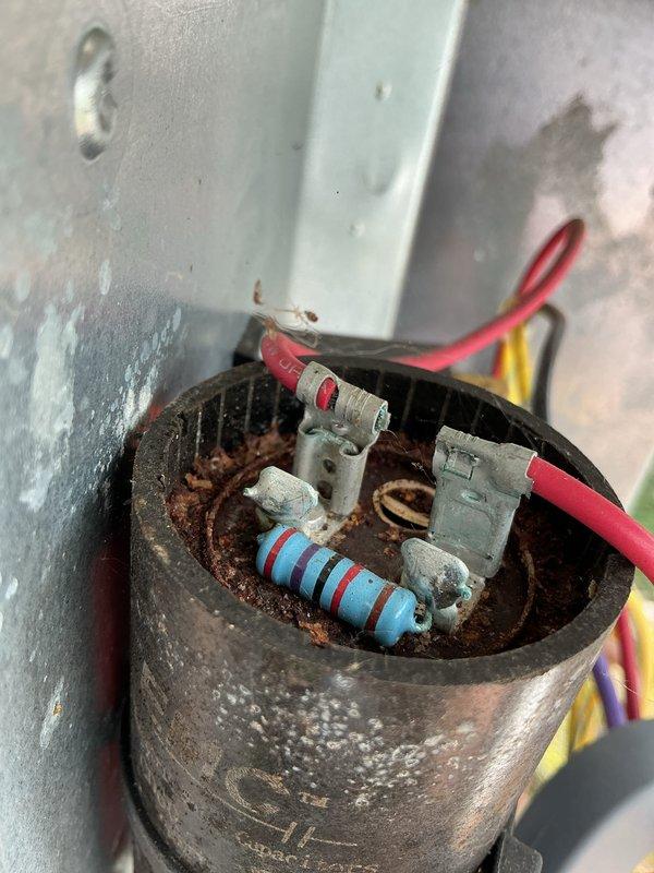 Completed annual cooling system tune-up and inspection on 9-year-old unit with warranty extending through June 2026. Inspected electrical components including capacitor and motor connections, noting significant rust and corrosion on capacitor housing exterior while internal components and connections remain functional. All wiring connections verified secure, system tested and confirmed operational; documented equipment condition with photos for service records.