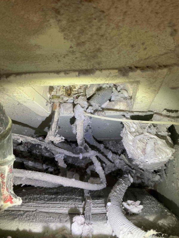 Completed comprehensive plumbing repairs addressing multiple fixture issues throughout the property. Repaired leaking kitchen sink faucet and dripping sprayer attachment, performed thorough cleaning and maintenance of shower head and handle assembly to restore proper water flow, and installed outdoor faucet extension for improved accessibility. Additionally, diagnosed and repaired washing machine water supply leak, which included addressing severely frosted refrigerant lines and pipe connections that had accumulated excessive ice buildup in the crawl space area, indicating a significant temperature differential issue that was resolved during the service call.