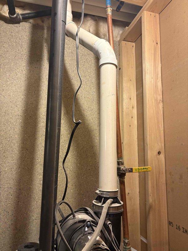 Responded to water heater leak at sweat joint on 11-year-old unit in owner-occupied residence. Upon arrival, customer had already shut off water supply due to active leak. Inspected copper piping connections and identified failed sweat joint as source of leak. Unit was producing hot water prior to shutdown but required immediate attention to prevent water damage. Documented plumbing configuration including PVC drain lines, copper supply lines with shutoff valve, and insulated piping within wooden frame structure. Photographed leak location and surrounding plumbing infrastructure for service records.
