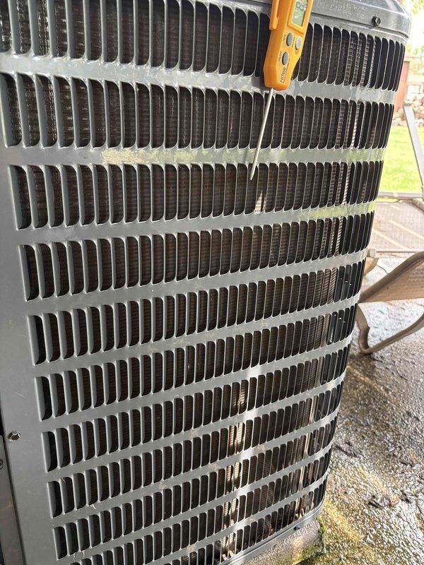 Responded to no cooling complaint on 6-year-old air conditioning system in manufactured home. Upon arrival, customer reported unit running but delivering insufficient cooling. Performed diagnostic evaluation of outdoor condenser unit using digital testing equipment to assess system performance and identify cause of reduced cooling capacity. Documented equipment condition through photographs showing condenser coil and exterior components for service records.