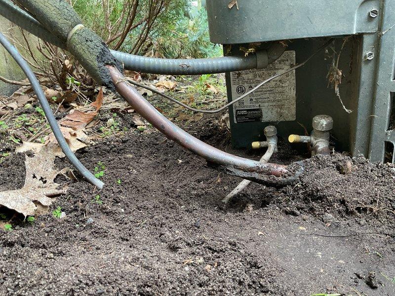 Completed comprehensive AC Super Tune-up on outdoor condensing unit. Removed significant accumulation of organic debris (leaves, twigs, moss, and nesting material) from electrical junction box and surrounding components to prevent potential electrical hazards and ensure proper system operation. Inspected refrigerant lines, service valves, and overall unit condition; system operational and ready for cooling season.