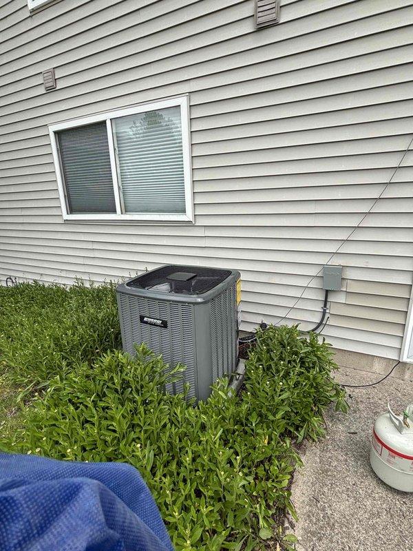 Completed full HVAC system replacement including outdoor condensing unit and indoor air handler. Installed new gray condensing unit on existing concrete pad with proper clearances from foundation and landscaping. Connected refrigerant lines, electrical service, and condensate drainage per manufacturer specifications. Mounted new air handler in basement utility area with integration to existing ductwork system, including galvanized supply and return plenums. Installed new digital thermostat control for system operation. Verified proper airflow, refrigerant charge, and electrical connections. System tested and operational upon completion.