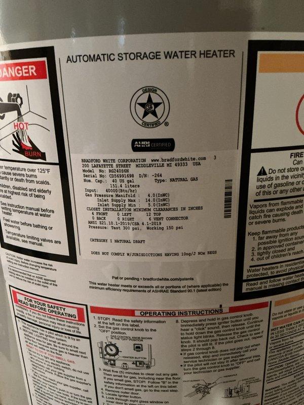 Completed installation of a 40-gallon Bradford White natural gas water heater in basement utility room. Unit was properly vented with metallic vent pipe, connected to existing copper supply lines with brass fittings, and installed according to manufacturer specifications and local code requirements.
