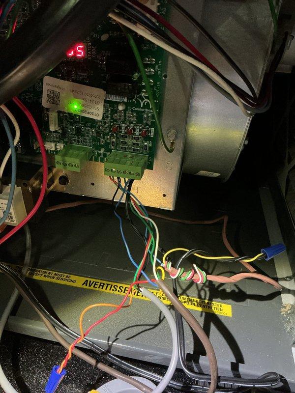 Responded to no cooling call on 2-year-old EnergiAir system. Upon arrival, unit was completely non-responsive. Accessed control board and performed diagnostic testing using digital manifold gauges. Identified control board displaying error code "-5" indicating communication or sensor fault. Inspected all wire connections at terminal blocks, verified proper voltage supply, and checked low-voltage transformer output. Traced wiring harness for potential shorts or loose connections. Control board failure determined to be root cause of system shutdown. Documented existing installation with photos showing circuit board configuration, wire routing, and component layout for warranty processing. System requires control board replacement to restore cooling operation.