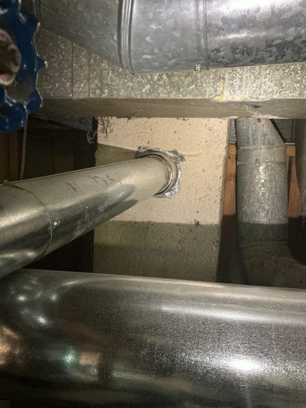 Completed water heater estimate for 16-year-old Lochinvar unit located in basement utility area alongside Precise Comfort furnace. Documented existing installation including all piping connections, venting configuration, and surrounding mechanical infrastructure through detailed photography for replacement proposal.