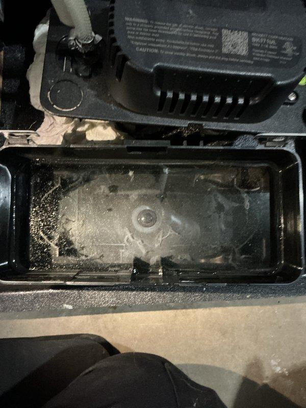 Completed annual furnace tune-up on Carrier unit model WT 12-2034. Inspected condensate drain pan in attic space, noting moisture accumulation and sediment buildup but confirming proper drainage function. Examined internal components including transformer, wiring connections, and compartment housing, all found in operational condition with normal wear patterns. System tested and verified operational, documentation photos captured for service records.