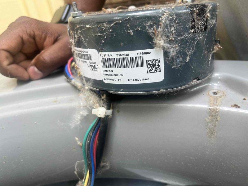 Responded to no cooling complaint on 6-year-old Luxaire system that was short cycling after one minute of operation. Upon inspection, found condenser fan motor heavily contaminated with lint and debris accumulation, causing motor overheating and thermal shutdown. Removed failed motor, documented condition with photographs, and replaced with new motor assembly. Verified proper electrical connections, tested system operation, and confirmed unit running normally with adequate cooling performance.