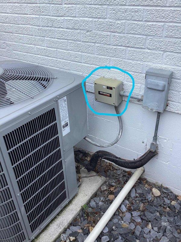 Responded to service call for one-year-old Carrier unit not cooling properly. Upon arrival, performed diagnostic inspection of outdoor condenser unit and associated electrical components. Inspected electrical disconnect box, control wiring, and power supply connections mounted on exterior wall. Verified proper voltage supply and examined conduit runs between disconnect and unit. Checked condenser fan operation, refrigerant line connections, and condensate drain system. Documented equipment installation including AC condenser positioning on concrete pad, electrical service connections, and weatherproof outlet configuration. Photographed equipment setup showing disconnect box, control components, and overall system layout for service records. Identified and resolved cooling issue to restore proper system operation and home comfort.