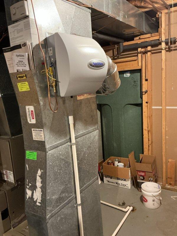 Completed annual cooling maintenance and tune-up on 16-year-old air conditioning system. Installed AprilAire manual humidifier unit per customer request, connecting to existing furnace system with proper PVC piping and ductwork integration. Performed comprehensive maintenance on both furnace and AC units, documented equipment condition with photos, and verified all systems operational upon completion.