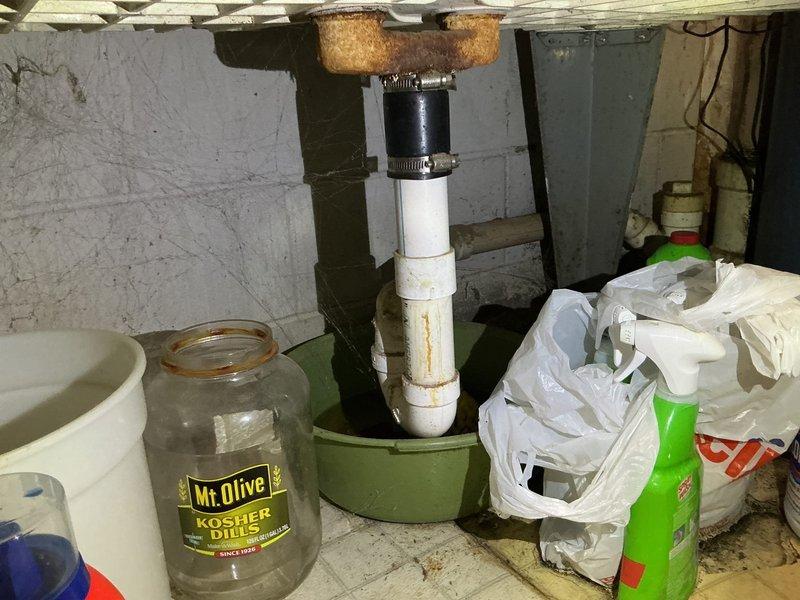 Replaced broken basement washtub faucet that had been accidentally damaged, with spout and handles broken off flush with wall. Installed new faucet assembly on existing copper supply lines, restoring full water service to the utility sink.