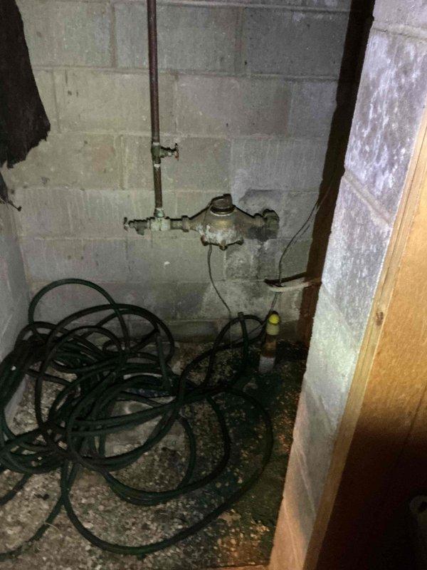 Replaced broken basement washtub faucet that had been accidentally damaged, with spout and handles broken off flush with wall. Installed new faucet assembly on existing copper supply lines, restoring full water service to the utility sink.