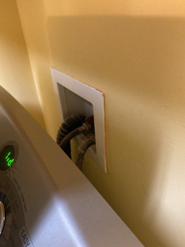 Responded to service call regarding slow-flushing toilet and banging noise in plumbing when washing machine operates. Inspected water heater installation and associated piping system in utility area. Observed condensation on vertical discharge piping from water heater, indicating potential thermal expansion issues that may contribute to hydraulic shock (water hammer) during appliance operation. Evaluated plumbing configuration and drainage system accessibility through wall access panel near laundry area. Documented conditions of water supply lines, discharge piping, and connections to identify source of pressure fluctuations causing banging noise and restricted toilet flush performance.