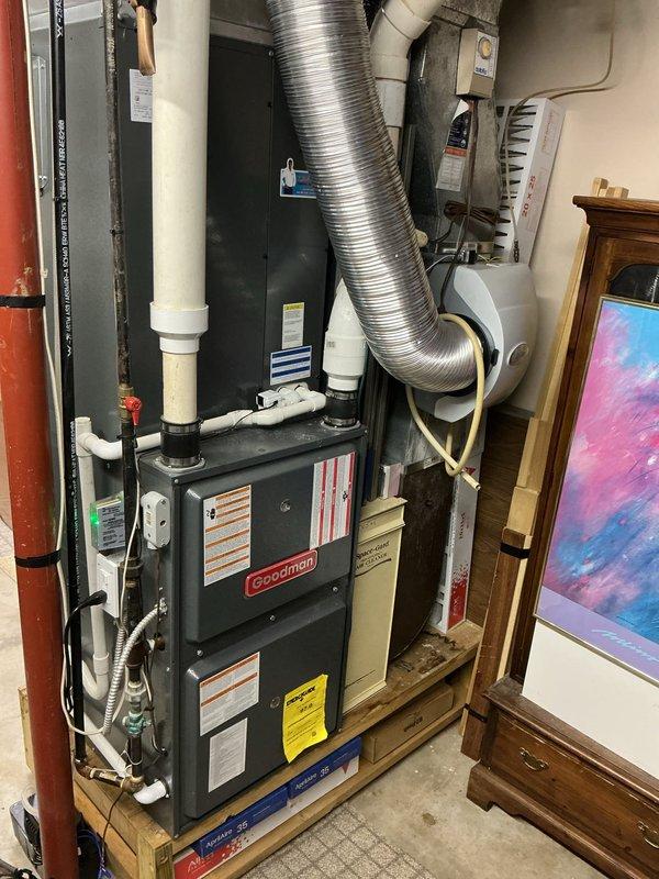 Completed annual AC tune-up on Goodman HVAC system. Performed standard cooling season maintenance including inspection of outdoor condenser unit, refrigerant level verification, electrical connection assessment, and air handler evaluation. Documented equipment condition with photographs showing furnace, ductwork, and associated mechanical components in basement utility area. Customer previously missed scheduled furnace tune-up; partial heating system inspection may be requested at later date to complete full annual maintenance cycle.