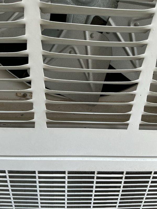 Responded to no-cooling complaint on 15-year-old air conditioning system with operational blower motor but no refrigerant cooling. Accessed furnace/air handler unit to inspect internal components and blower assembly. Evaluated compressor operation, refrigerant system components, and electrical connections to diagnose cooling failure. Documented equipment condition and internal components including blower fan assembly and heat exchanger configuration for diagnostic purposes.
