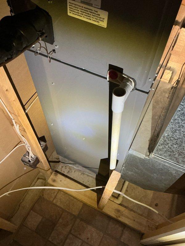 Conducted comprehensive evaluation of existing HVAC system for furnace and air conditioning replacement estimate due to non-operational AC unit. Inspected air handler unit installed in basement utility area, documented equipment specifications, condensate drainage system with PVC piping, and overall system configuration within confined mechanical space. Assessed installation requirements, electrical connections, ductwork connections, and structural considerations for potential equipment replacement to provide customer with accurate estimate for new furnace and AC system.