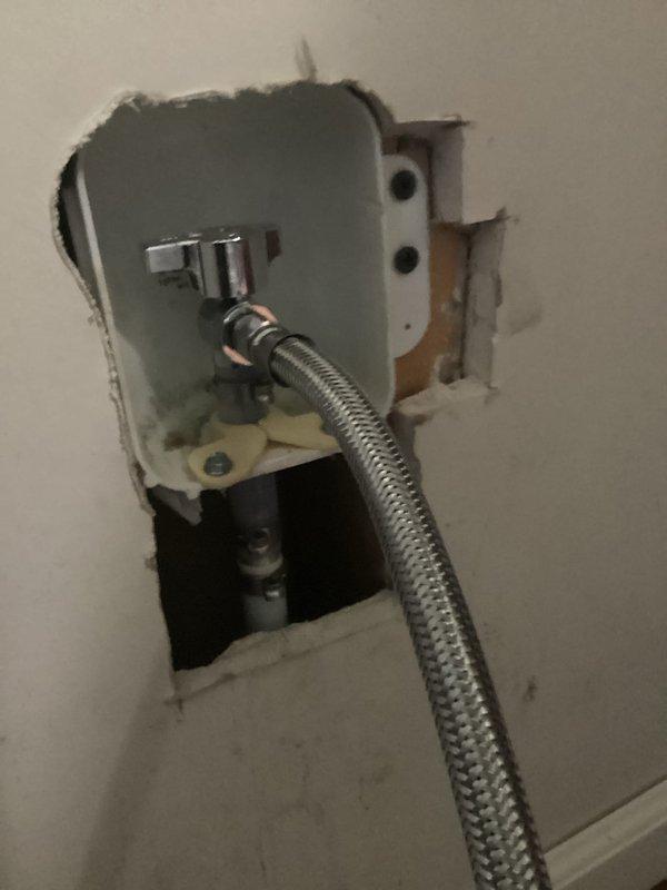 Installed shut-off valve for refrigerator water supply line to address leaking issue that was causing freezing problems. Accessed supply line through wall cavity, mounted valve assembly with proper fittings, and connected braided stainless steel flex line to new valve. Verified proper operation and no leaks at connection points.