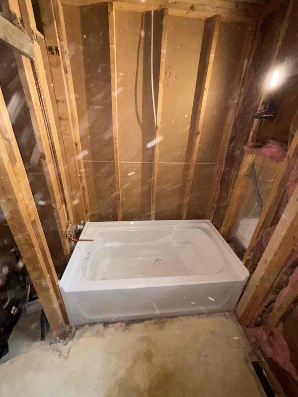 Completed comprehensive bathroom remodel plumbing installation over 1.5 days, including removal of existing fixtures and installation of new alcove-style bathtub with proper rough-in plumbing connections. Coordinated with electrical contractor for integrated services, stripped walls to studs, installed insulation and backing materials, and prepared all plumbing infrastructure for final finish work and fixture connections.