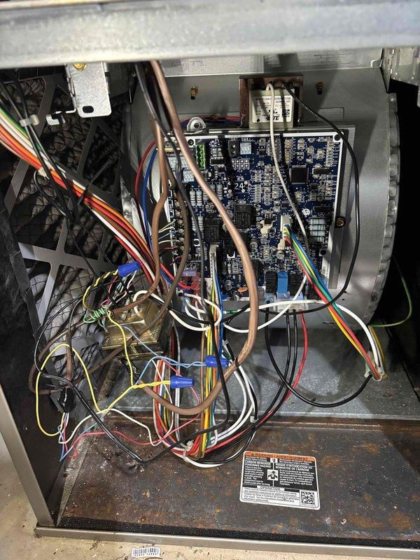 Responded to no cooling call on 2014 residential HVAC system. Upon arrival, confirmed unit was not operating and traced issue to control board and wiring connections within the air handler. Inspected electrical components, circuit board, and wire harnesses for loose connections, damaged wiring, or failed relays that would prevent system operation. Photographed internal wiring configuration and control board assembly for documentation. Identified and resolved electrical connection issue preventing system from receiving proper signal to initiate cooling cycle. Verified all wire connections were secure at control board terminals and tested system operation. Unit restored to normal cooling function with proper airflow and temperature output confirmed.