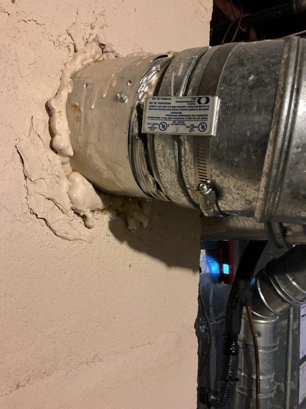 Completed rental inspection of 24-year-old Bryant Plus 80 furnace system. Documented equipment condition through photographs, noting deteriorated wall penetration around flexible ductwork with cracked and crumbling plaster surrounding the duct connection point requiring attention. Verified furnace model information and assessed overall HVAC system condition in basement mechanical room.
