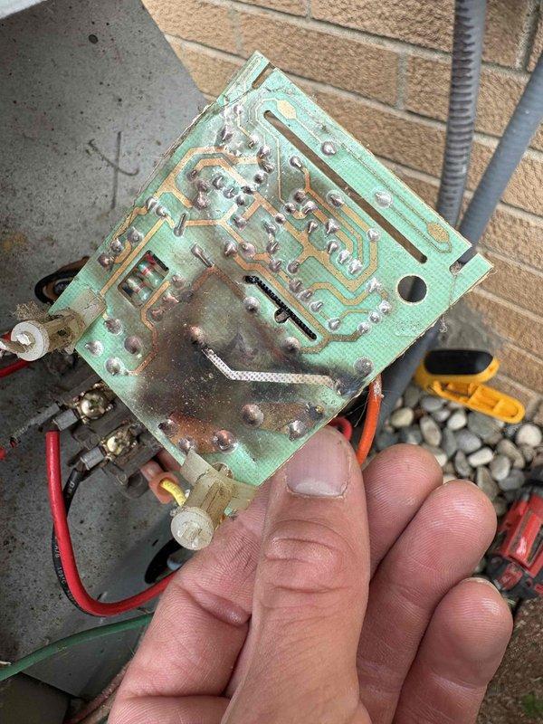 Responded to service call for 23-year-old air conditioning unit not operating. Upon inspection, discovered the control board had suffered catastrophic failure due to severe corrosion and moisture damage. The circuit board exhibited extensive oxidation on copper traces, degraded electronic components, and rust throughout, rendering it completely non-functional. Removed the failed control board from the electrical enclosure and documented the condition. The level of corrosion indicated prolonged exposure to moisture intrusion, which compromised the integrity of the entire board and all connected components. Advised customer that control board replacement would be necessary to restore system operation.