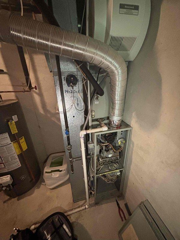 Responded to no-cooling complaint on residential air conditioning system. Upon arrival, confirmed air handler blower motor was inoperative while heating function remained intact. Performed diagnostic inspection of furnace and air handler assembly, removing access panels to assess internal components including blower assembly, control board, and electrical connections. Documented existing equipment condition with photographs showing internal components, wiring configuration, and overall system age. System exhibits signs of advanced wear consistent with aging HVAC equipment. Customer advised of findings and provided recommendations for repair or replacement options given the age and condition of the unit.