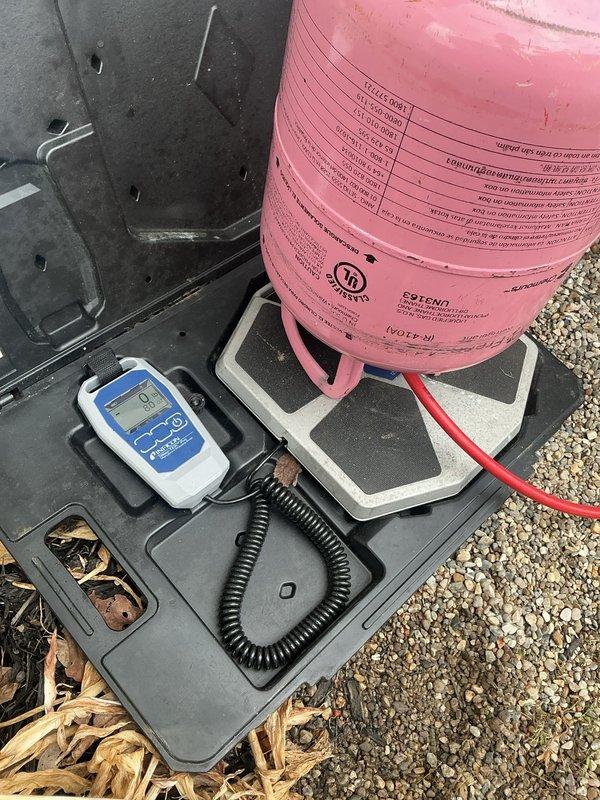 # NC-No Cool Service Completed

Responded to no cooling complaint on 12+ year old Carrier system with condenser running but no airflow and red indicator light at furnace. Upon arrival, diagnosed system refrigerant levels and electrical connections at outdoor unit. Connected manifold gauges and recovery equipment to assess refrigerant charge and system pressures. Inspected condensate drain lines, PVC piping connections, and electrical conduit at exterior installation. Evaluated furnace blower operation and control board status indicated by red diagnostic light. Utilized digital testing instruments to measure system performance parameters. Addressed airflow issue preventing cooling delivery to occupied space while condenser remained operational.