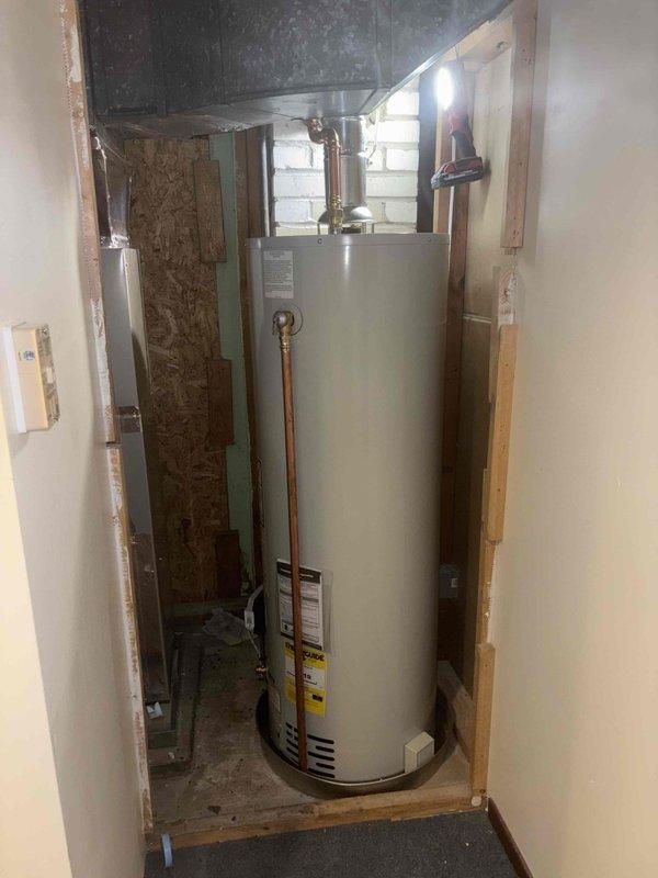 Completed installation of a 40-gallon natural gas tall water heater in residential utility closet. Successfully connected copper supply lines, installed temperature and pressure relief valve, and established proper venting with metallic ductwork. All plumbing connections secured with brass fittings and tested for proper operation.