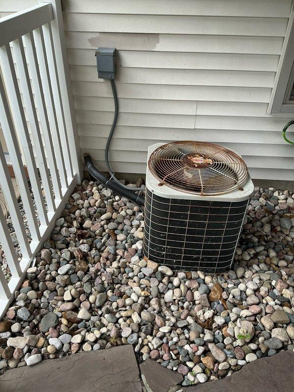 Conducted on-site assessment of 16-year-old residential air conditioning system to provide replacement estimate. Evaluated outdoor condenser unit with visible copper fan assembly and condenser coils, noting age-related weathering and potential undersizing concerns for current structure. Inspected indoor air handler cabinet with condensate drain pan and ductwork connections in basement utility area. Documented existing equipment specifications, installation configuration, and operational capacity to determine proper system sizing requirements. Provided comprehensive replacement options and recommendations for appropriately-sized HVAC equipment to meet heating and cooling demands of residence.