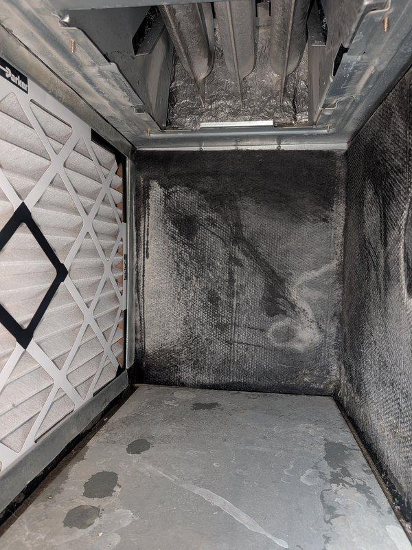 Responded to ongoing AC cooling deficiency complaint on Carrier unit model WT 04-2031. Upon inspection, found evaporator coil and filter media heavily soiled with dust and debris accumulation, restricting airflow and reducing system efficiency. Documented refrigerant service port area showing R-454B refrigerant type and verified system accessibility. Photographed compromised filter condition and internal plenum contamination contributing to diminished cooling performance. Recommended thorough coil cleaning, filter replacement, and complete system evaluation to address recurring issue and restore proper airflow and cooling capacity.
