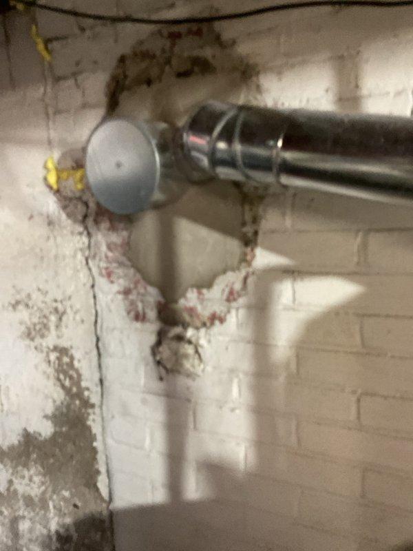 Provided estimate for replacement of aging residential water heater unit (9-12 years old) that is no longer functioning properly. Scope of work includes complete removal and disposal of existing water heater and installation of new unit with proper connections to existing copper supply lines, shut-off valves, and expansion tank. Minor wall deterioration and moisture damage observed in installation area, indicating possible historical water heater issues.