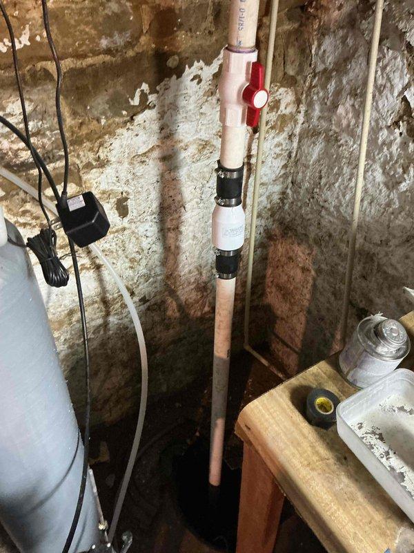 Responded to sump pump failure where unit was running continuously but not pumping water. Upon inspection of the 180-year-old property's basement sump pit, diagnosed malfunctioning pump motor and float switch assembly. Removed failed sump pump unit from concrete pit and installed replacement pump with new discharge piping connections to existing PVC system. Tested pump operation through multiple cycles to verify proper float switch engagement and automatic shutoff functionality. Confirmed adequate water discharge through vertical piping and verified no leaks at connection points. System now operating correctly with proper on/off cycling.