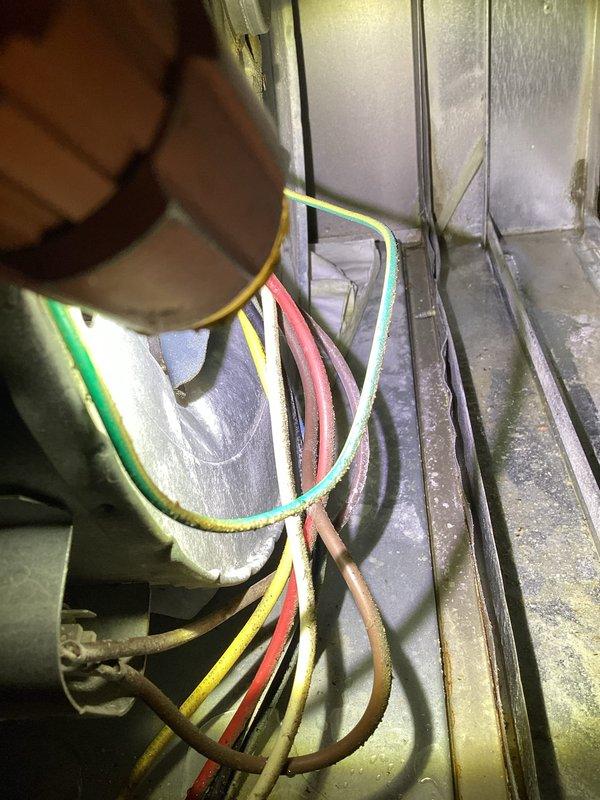 Responded to cooling complaint where system was running but unable to maintain setpoint, with thermostat reading 74°F despite being set to 70°F. Upon inspection, discovered water accumulation in the blower unit and extensive frost/ice buildup on evaporator coil and condensate drain lines. Identified restricted airflow and potential refrigerant issue causing freezing conditions within the air handler. Inspected electrical connections and wiring at the unit. Documented conditions with photos showing frozen condensate lines and ice-covered components. System exhibited symptoms consistent with restricted airflow or low refrigerant charge, similar to previous year's service history. Further diagnostics recommended to determine root cause of recurring cooling capacity issues and water intrusion in blower compartment.