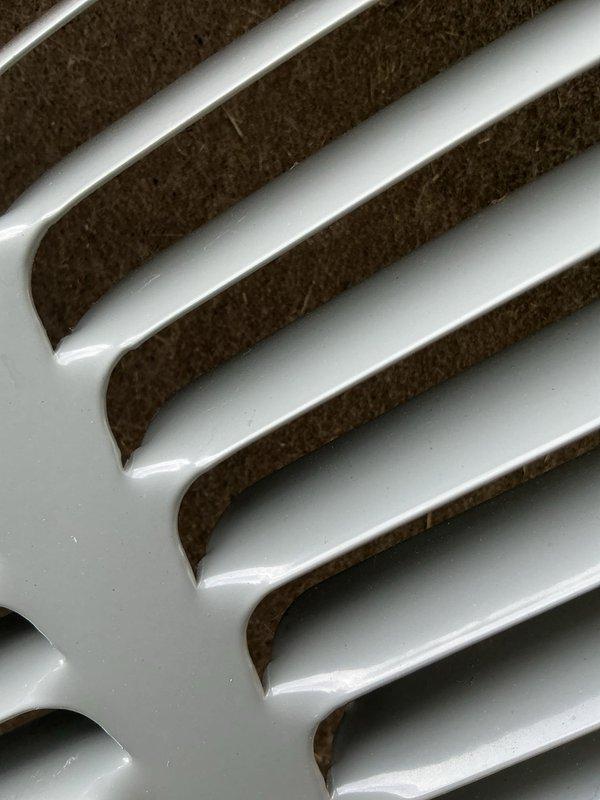 Responded to no-cooling complaint on residential air conditioning system. Upon inspection, found evaporator coil with moderate dust and debris accumulation affecting airflow and heat transfer efficiency. Cleaned evaporator coil fins and grille assembly, removed obstructions from ventilation components, and verified proper airflow restoration. System tested and confirmed cooling to setpoint temperature upon completion.