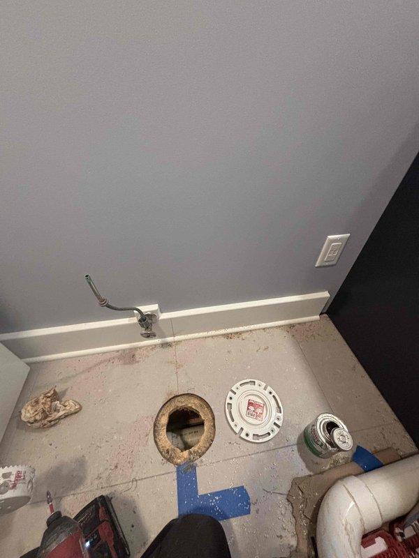 Replaced corroded toilet flange assembly showing significant rust deterioration around the drain opening. Removed old flange, cleaned mounting surface, and installed new PVC flange with proper seal to prevent future leaks and ensure secure toilet mounting.