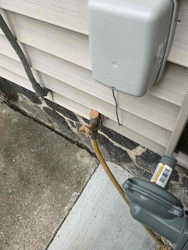 Responded to outdoor water spigot that would not shut off, requiring indoor water supply to be turned off to stop flow. Upon arrival, inspected the recently replaced exterior hose bib on 119-year-old residential structure. Diagnosed faulty valve stem or seat washer in the brass hose bib assembly preventing proper closure. Shut off water supply at interior shut-off valve, removed defective hose bib, and installed replacement frost-proof sillcock with proper seating and compression. Verified all connections were secure at wall penetration point. Restored water supply and tested operation through multiple on/off cycles to confirm complete shutoff with no residual dripping or leaking. Outdoor faucet now functioning properly with full water flow control.