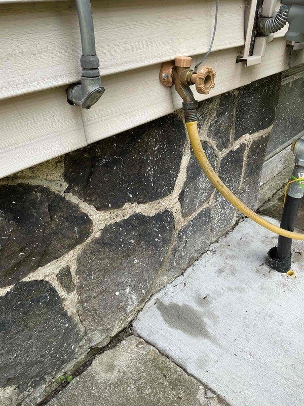 Responded to outdoor water spigot that would not shut off, requiring indoor water supply to be turned off to stop flow. Upon arrival, inspected the recently replaced exterior hose bib on 119-year-old residential structure. Diagnosed faulty valve stem or seat washer in the brass hose bib assembly preventing proper closure. Shut off water supply at interior shut-off valve, removed defective hose bib, and installed replacement frost-proof sillcock with proper seating and compression. Verified all connections were secure at wall penetration point. Restored water supply and tested operation through multiple on/off cycles to confirm complete shutoff with no residual dripping or leaking. Outdoor faucet now functioning properly with full water flow control.