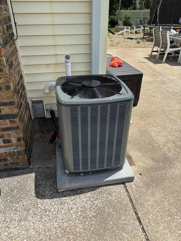 Completed full HVAC system installation including new furnace and air conditioning unit. Installed gray furnace unit in basement on black drip pan with proper PVC venting and ductwork connections to existing system. Mounted outdoor condensing unit on concrete pad with appropriate refrigerant lines, electrical connections, and condensate drainage. Verified all connections, tested system operation, and confirmed proper airflow throughout the residence.