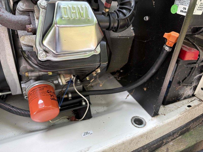 Responded to service call for standby generator that failed to activate during power outages over a two-month period, leaving entire residence without backup power. Upon arrival, performed comprehensive diagnostic inspection of generator system including engine compartment, fuel delivery system, electrical connections, and control circuitry. Inspected oil reservoir, filter assembly, and associated engine components for proper fluid levels and mechanical integrity. Examined transfer switch operation and verified proper connection to main electrical panel. Documented equipment condition through photographic records showing engine compartment details including oil system components, filters, hoses, and electrical connections. Generator age and manufacturer information undetermined due to legacy installation from original home construction. Provided customer with contact protocol for service updates and completion notification at alternate telephone number as requested.