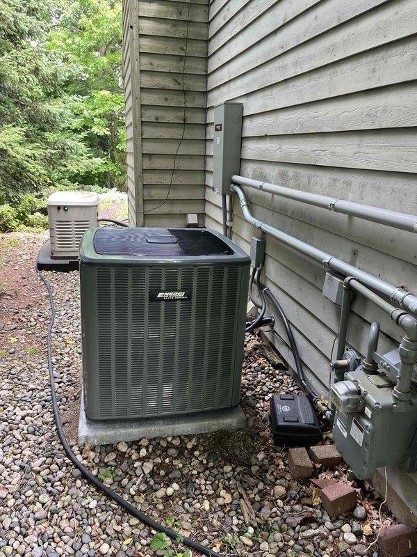 Completed full HVAC system installation including outdoor condensing unit and indoor air handler. Condensing unit was positioned on concrete pad with proper clearances, electrical disconnect box mounted to exterior wall, and refrigerant lines run with PVC conduit protection. Air handler installed in garage/utility space with insulated flex duct connection, condensate drain line plumbed with PVC piping, and all electrical connections completed per manufacturer specifications. System tested and verified operational upon completion.