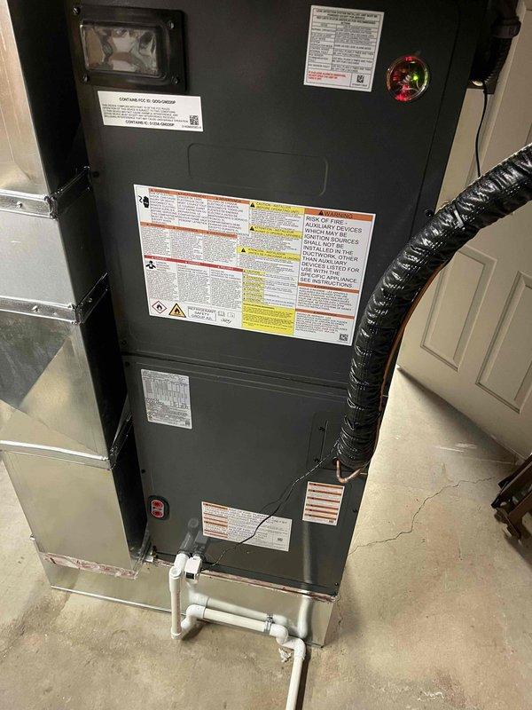 Completed full HVAC system installation including outdoor condensing unit and indoor air handler. Condensing unit was positioned on concrete pad with proper clearances, electrical disconnect box mounted to exterior wall, and refrigerant lines run with PVC conduit protection. Air handler installed in garage/utility space with insulated flex duct connection, condensate drain line plumbed with PVC piping, and all electrical connections completed per manufacturer specifications. System tested and verified operational upon completion.