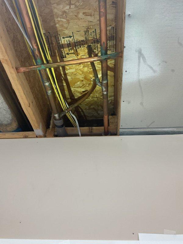 Responded to an early availability call for a leaky copper pipe. Upon inspection, located the source of the leak in the copper plumbing line running through the framed wall space. Repaired the compromised section of copper piping and verified all connections were secure and leak-free. Confirmed proper water flow and pressure restoration to the shower fixture following the repair.