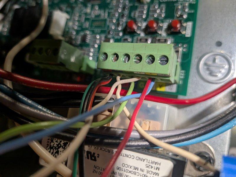 Responded to no cooling complaint on residential air conditioning system. Upon inspection, found thermostat control wiring and low-voltage connections at air handler required attention. Verified proper wiring configuration at Copeland control board and terminal connections (Y, G, C, R terminals). Confirmed transformer output voltage within specifications and traced control circuit from thermostat through to air handler. Inspected internal control board components, relay contacts, and terminal block connections for proper seating and continuity. System had not been commissioned or tested following furnace replacement in previous season. Completed system startup procedures, verified proper thermostat communication with cooling equipment, and confirmed air conditioning unit now operating correctly with adequate cooling delivery throughout residence.