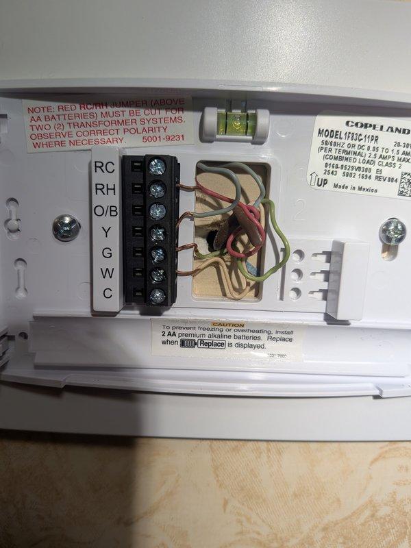Responded to no cooling complaint on residential air conditioning system. Upon inspection, found thermostat control wiring and low-voltage connections at air handler required attention. Verified proper wiring configuration at Copeland control board and terminal connections (Y, G, C, R terminals). Confirmed transformer output voltage within specifications and traced control circuit from thermostat through to air handler. Inspected internal control board components, relay contacts, and terminal block connections for proper seating and continuity. System had not been commissioned or tested following furnace replacement in previous season. Completed system startup procedures, verified proper thermostat communication with cooling equipment, and confirmed air conditioning unit now operating correctly with adequate cooling delivery throughout residence.