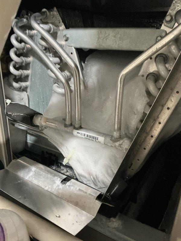 Responded to call for water leakage and reduced cooling performance on a 4-year-old system. Upon inspection, found water discharge from the unit and compromised cooling efficiency. Accessed interior components and examined evaporator coil assembly, refrigerant lines, and condensate drainage system. Inspected heat exchanger coils, mounting brackets, and drain pan for blockages or damage. Documented equipment condition with photos showing coil configuration, refrigerant distribution lines, and condensate collection system. All mechanical components, tubing connections, and mounting hardware were assessed for proper operation and potential sources of water intrusion affecting system performance.