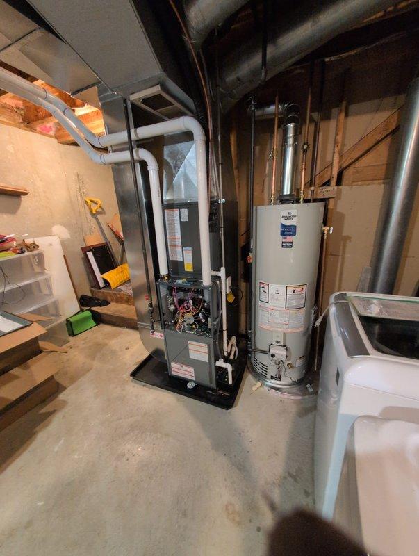 Successfully completed full HVAC system installation in basement utility area, including new furnace unit, air conditioning system integration, and water heater replacement. Installed dark-colored high-efficiency furnace with proper venting via white PVC piping, completed all electrical connections and wiring configurations, and verified internal components functioning correctly. Replaced existing water heater with new tall cylindrical unit, connected copper supply lines and brass fittings, and installed white expansion tank for proper pressure regulation. Routed all necessary ductwork, gas lines, and water lines according to code specifications. Coordinated Michigan Saves financing documentation through electronic signature system for customer approval. All equipment tested, operational, and left in clean working condition with access panels secured and utility area organized.