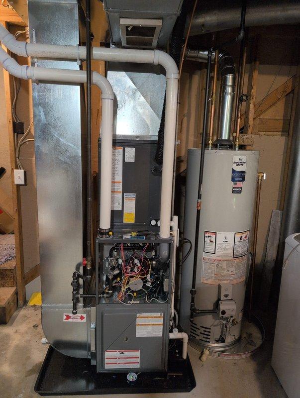 Successfully completed full HVAC system installation in basement utility area, including new furnace unit, air conditioning system integration, and water heater replacement. Installed dark-colored high-efficiency furnace with proper venting via white PVC piping, completed all electrical connections and wiring configurations, and verified internal components functioning correctly. Replaced existing water heater with new tall cylindrical unit, connected copper supply lines and brass fittings, and installed white expansion tank for proper pressure regulation. Routed all necessary ductwork, gas lines, and water lines according to code specifications. Coordinated Michigan Saves financing documentation through electronic signature system for customer approval. All equipment tested, operational, and left in clean working condition with access panels secured and utility area organized.