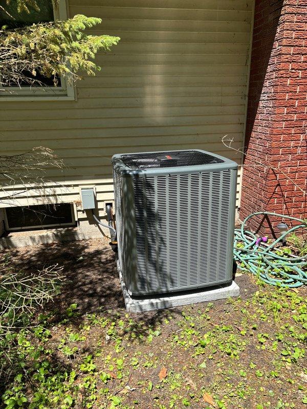 Completed full HVAC system installation including furnace, air conditioning unit, and water heater at residential property. Outdoor AC unit installed on concrete pad adjacent to building exterior with proper clearances and drainage considerations. Bradford White water heater installed in basement utility area with copper supply piping, brass shut-off valves, metallic exhaust venting, and electronic monitoring controls properly configured. All equipment positioned per manufacturer specifications, utility connections established, and systems tested for proper operation upon completion.